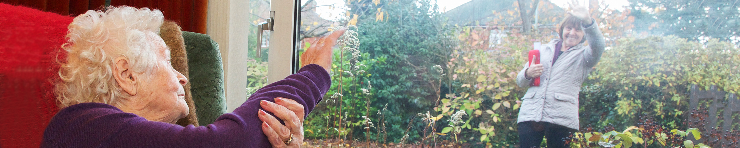 Independent living elderly client waving goodbye to her professional carer.