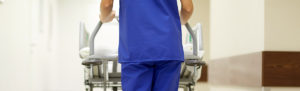 Nurse pushing hospital gurney