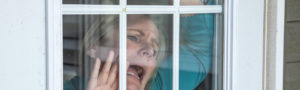 Woman at Window with Cabin Fever