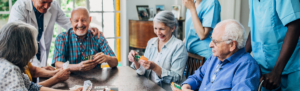 Senior living residents playing cards.