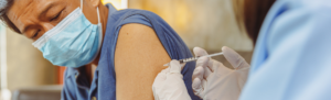 Man receiving a vaccine shot.