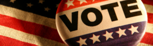Image of a pin that reads "vote"