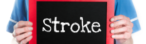 Medical professional holding a sign that states stroke.