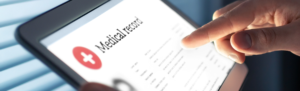 Person holding tablet that states medical record.