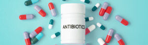 Image of capsules and a medication bottle that states 'antibiotics'.