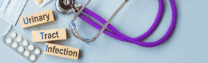 Medication, a stethoscope,, and mask on a blue background with the words Urinary Tract Infection on wooden blockis